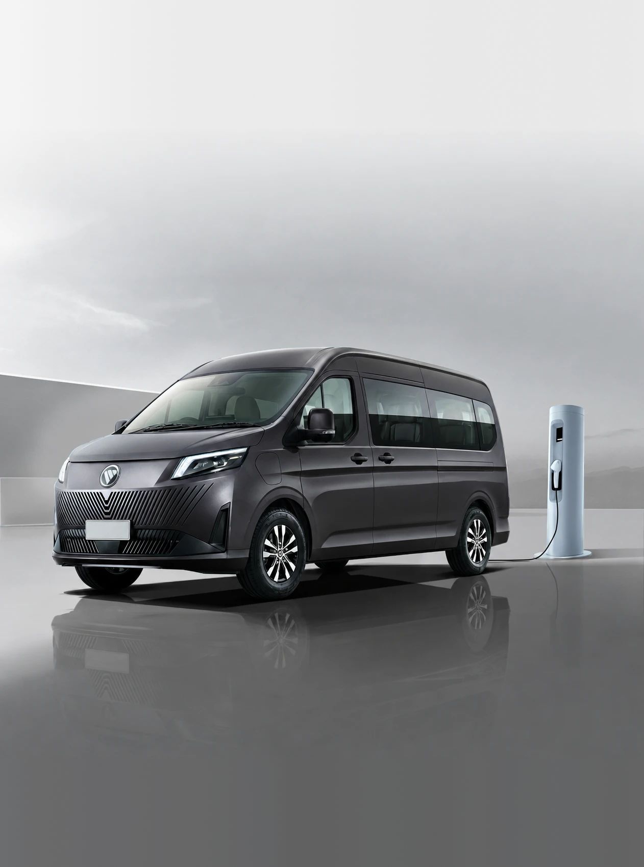 A dark grey Foton EView Grand plugged into a charging post