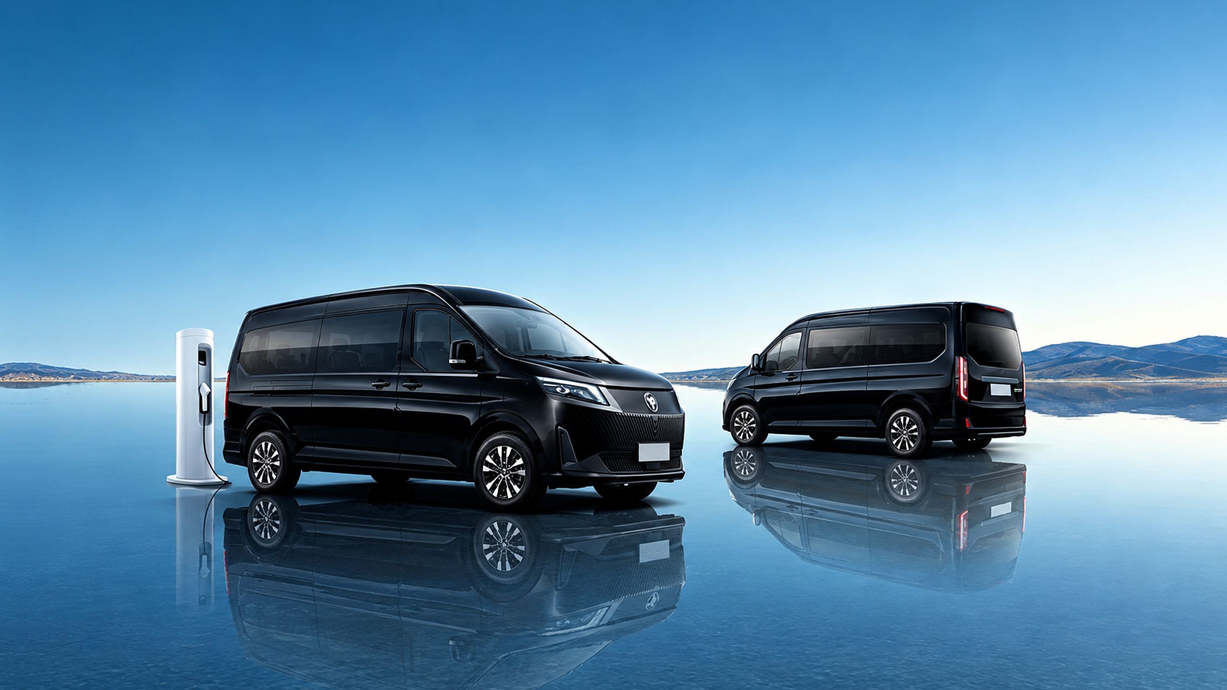 Two black Foton EView Grand vans at a charging post, reflected in still water